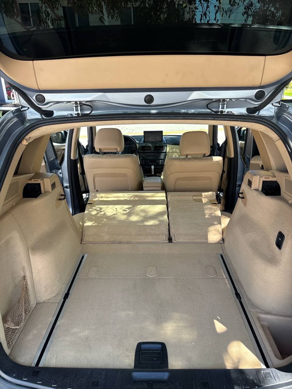 After mobile detailing showing the beige SUV cargo area cleaned