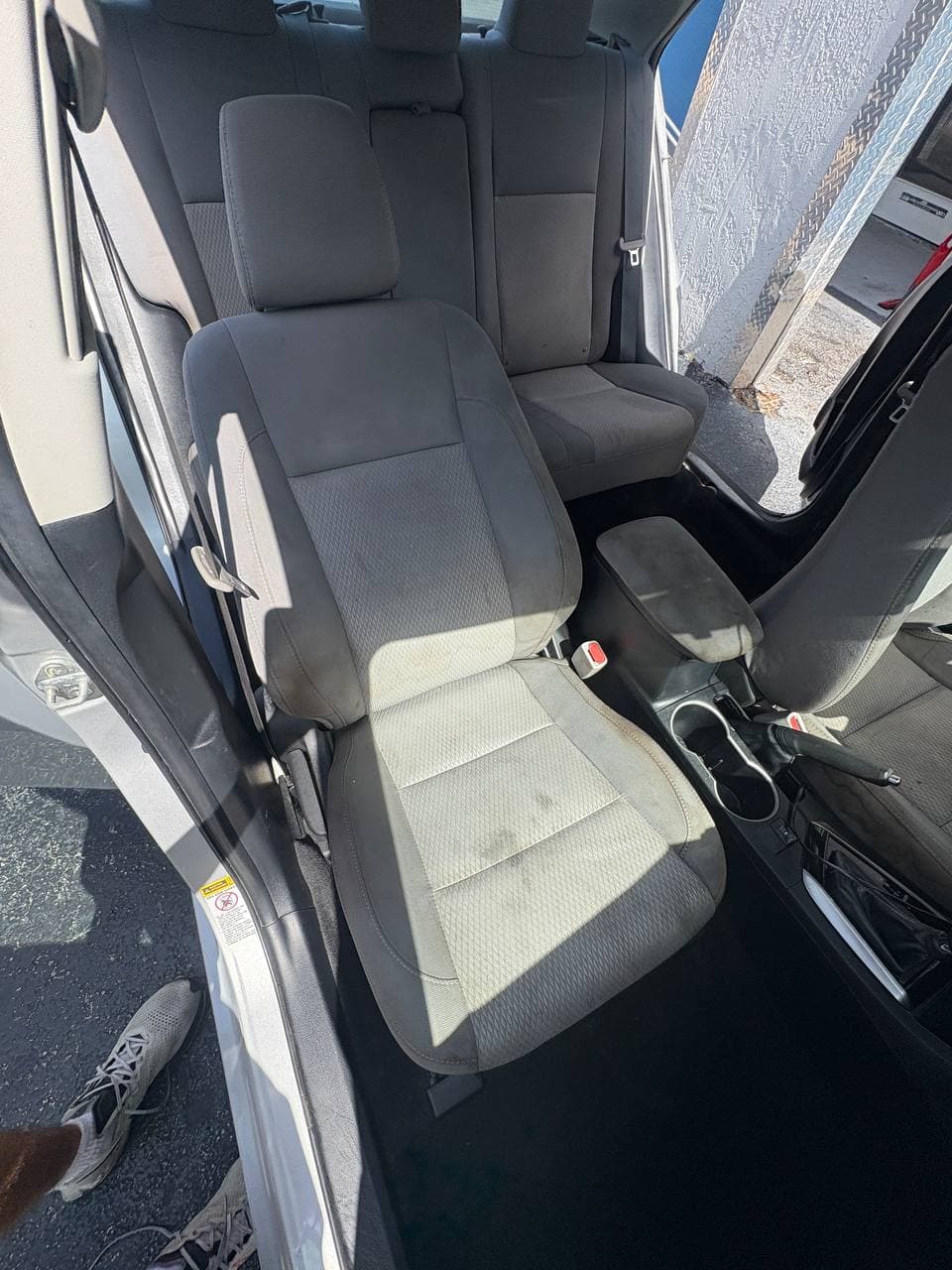 After mobile car detailing showing the same front seat cleaner with reduced staining