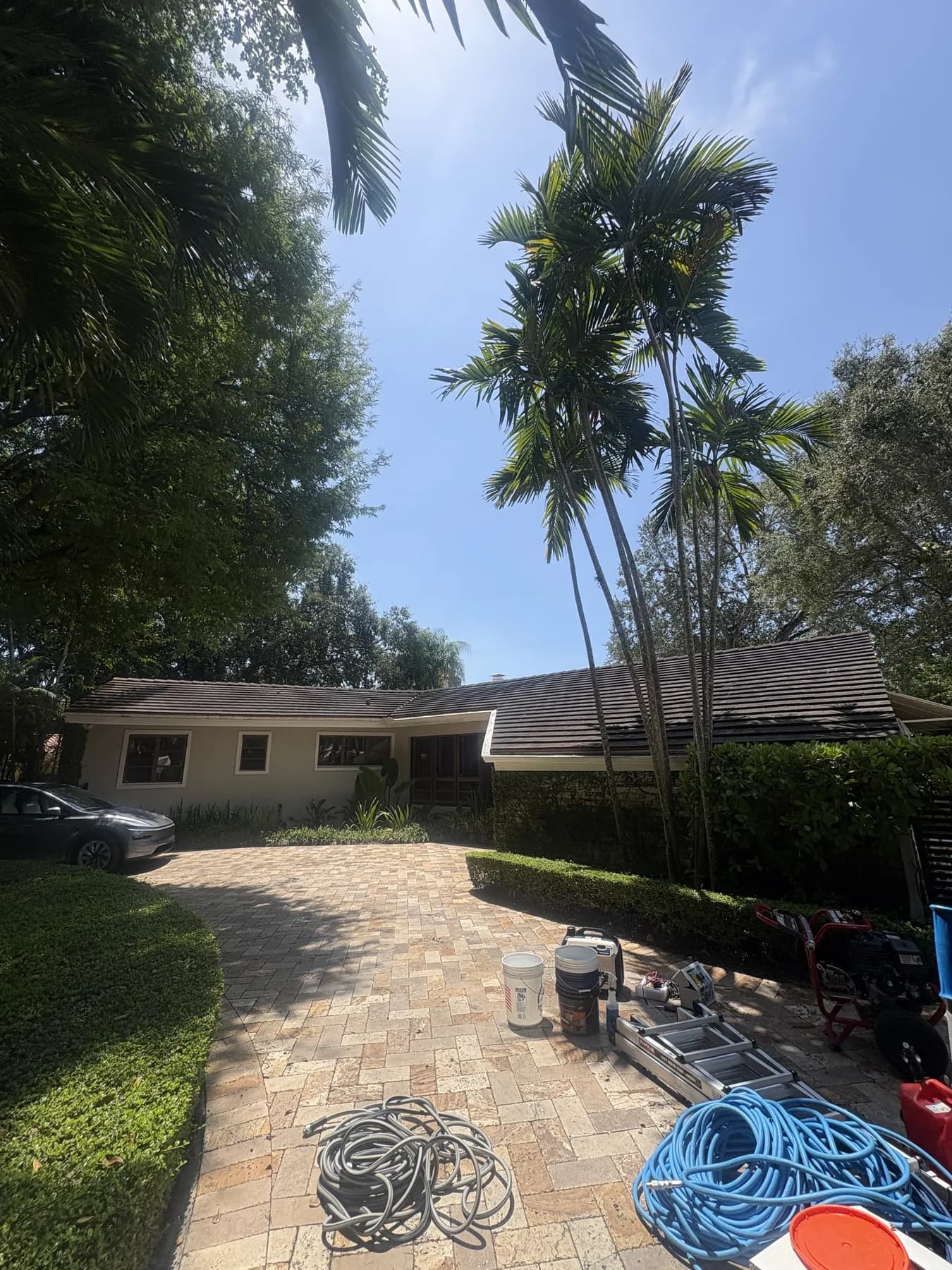 Project B house before roof cleaning with a dark stained tile roof